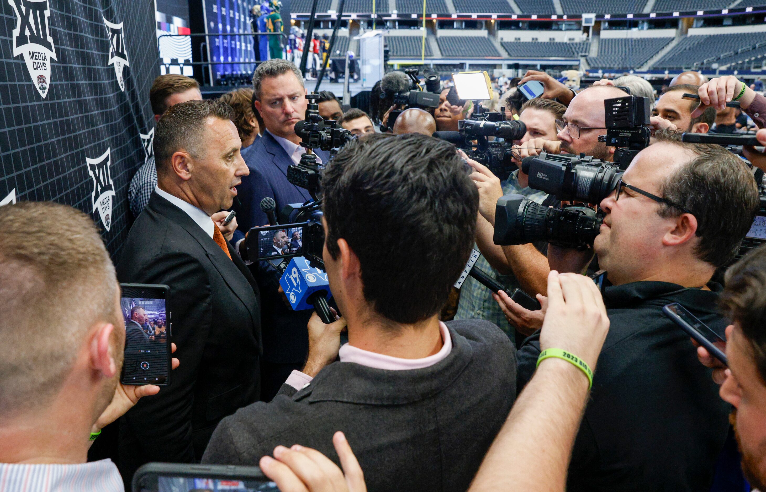 Texas head coach Steve Sarkisian (left) speaks with members of the media during the Big 12...