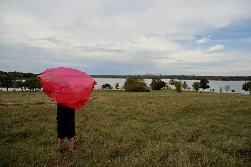  Noah McGough, 9, of Dallas, plays with his red poncho in the wind during the I Heart the...