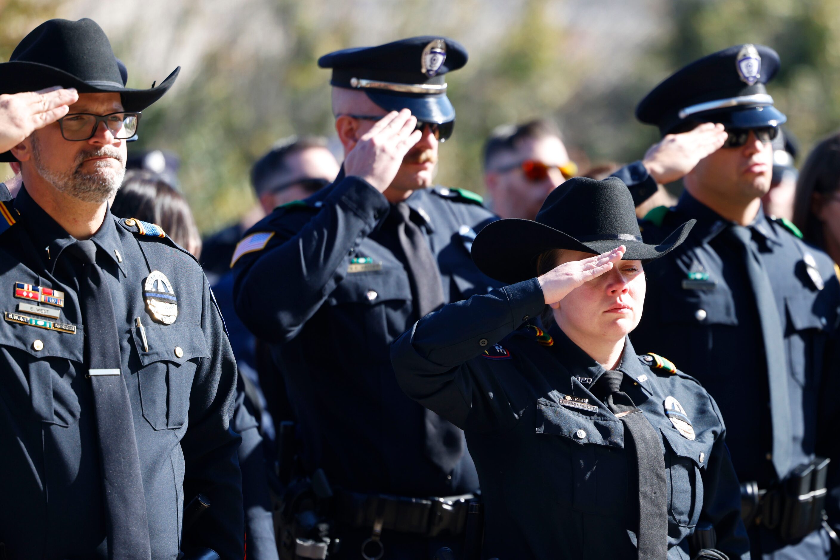 Greenville Police Officers salute during the funeral for Greenville police officer Cooper...