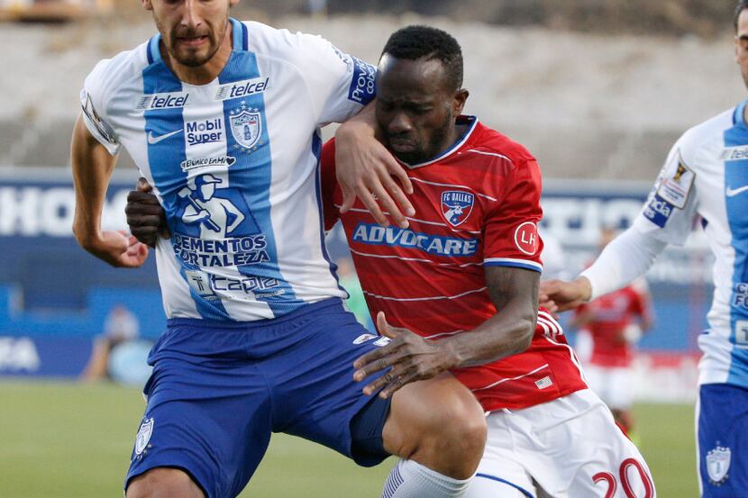 Pachuca defender Omar Gonzalez (4) and FC Dallas forward Roland Lamah (20) fight for...