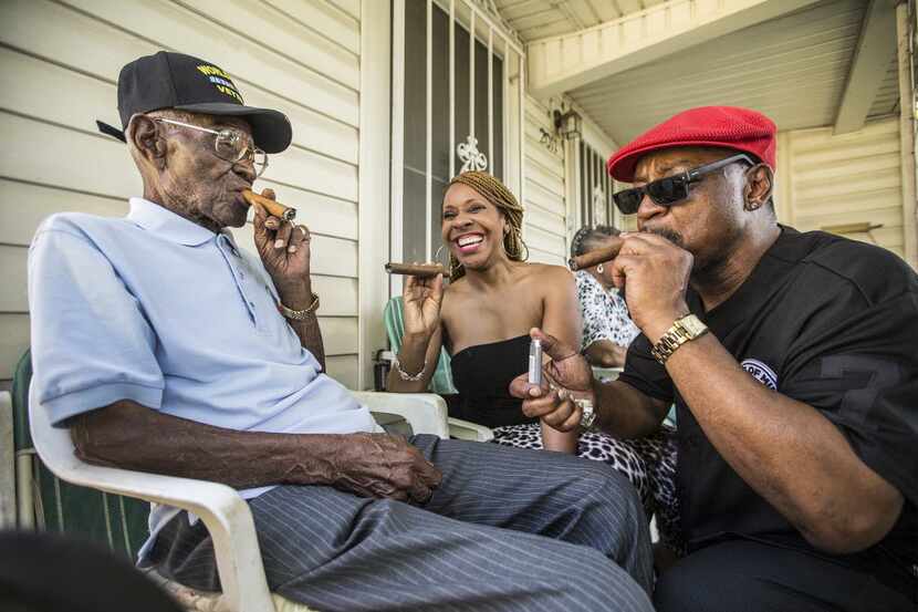 Richard Overton, left, smokes a cigar wit friends Donna Shorts, center and Martin Wilford in...