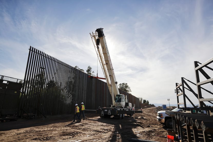 In this March 5, 2018, photo, construction continues on a new, taller version of the border...