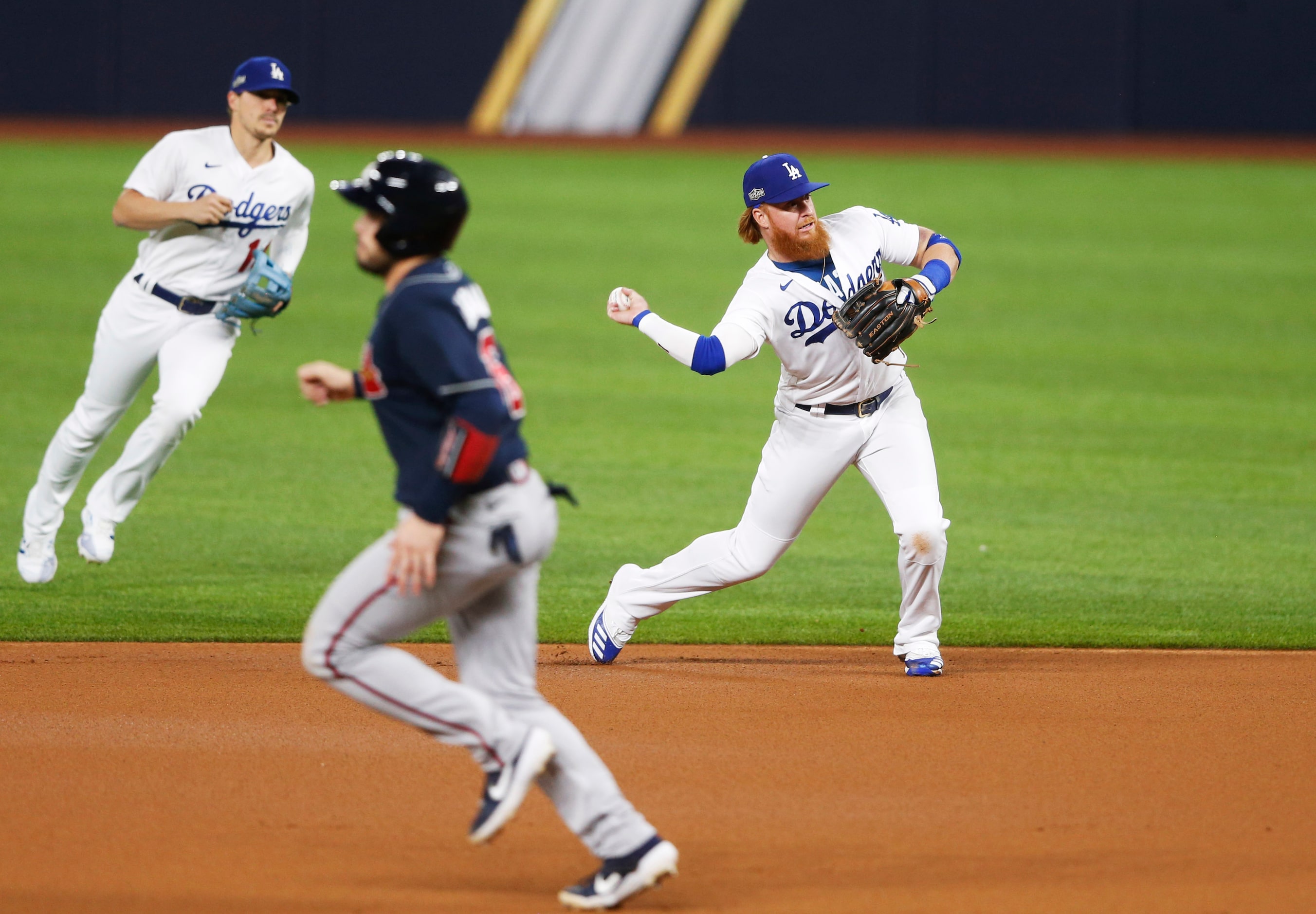 Los Angeles Dodgers third baseman Justin Turner (10) throws to first to get out Atlanta...