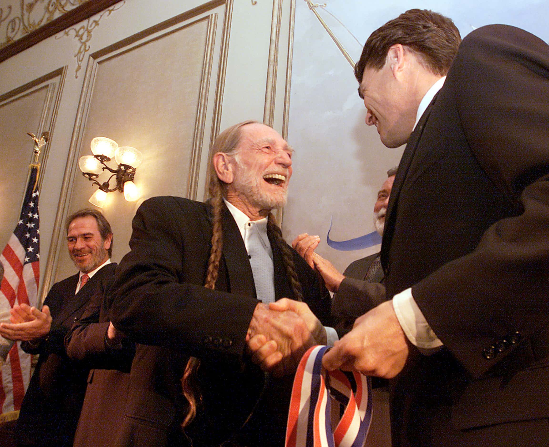 2001 - Musician Willie Nelson receives the music award from Texas Gov. Rick Perry during the...