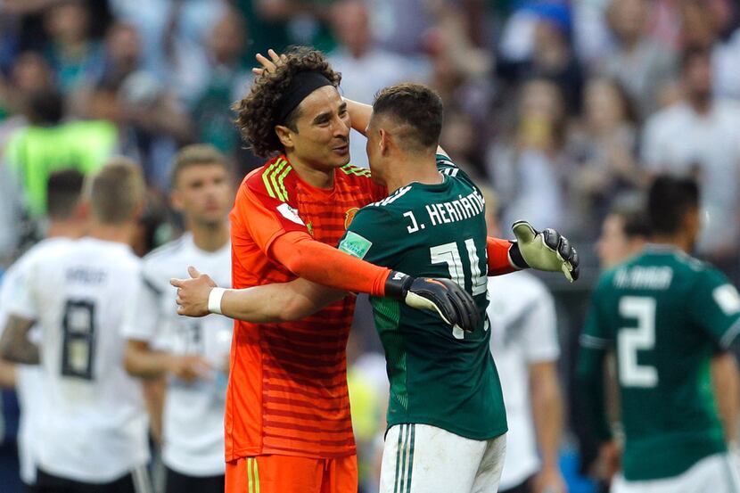 Mexico's Javier Hernandez and goalkeeper Guillermo Ochoa, left, celebrate at the end of the...