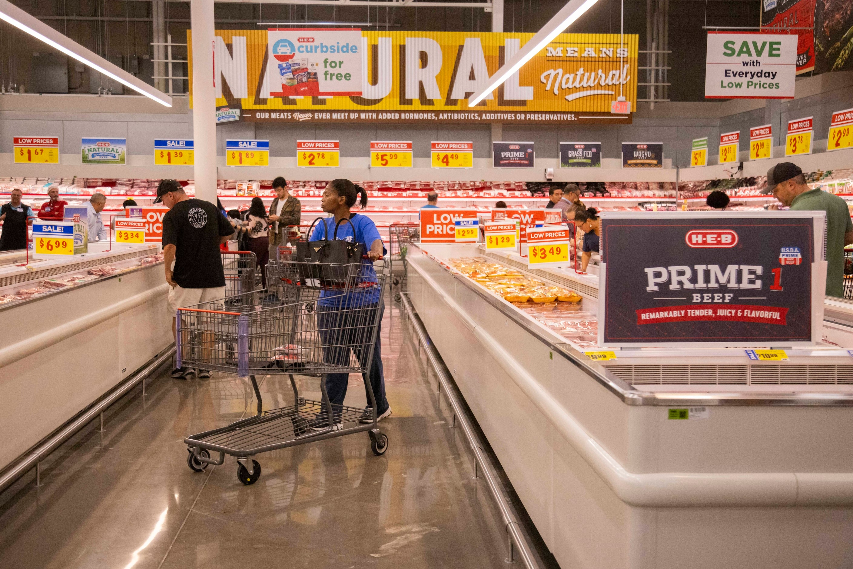 People shop the meat section during the grand opening of the H-E-B store in Allen on...