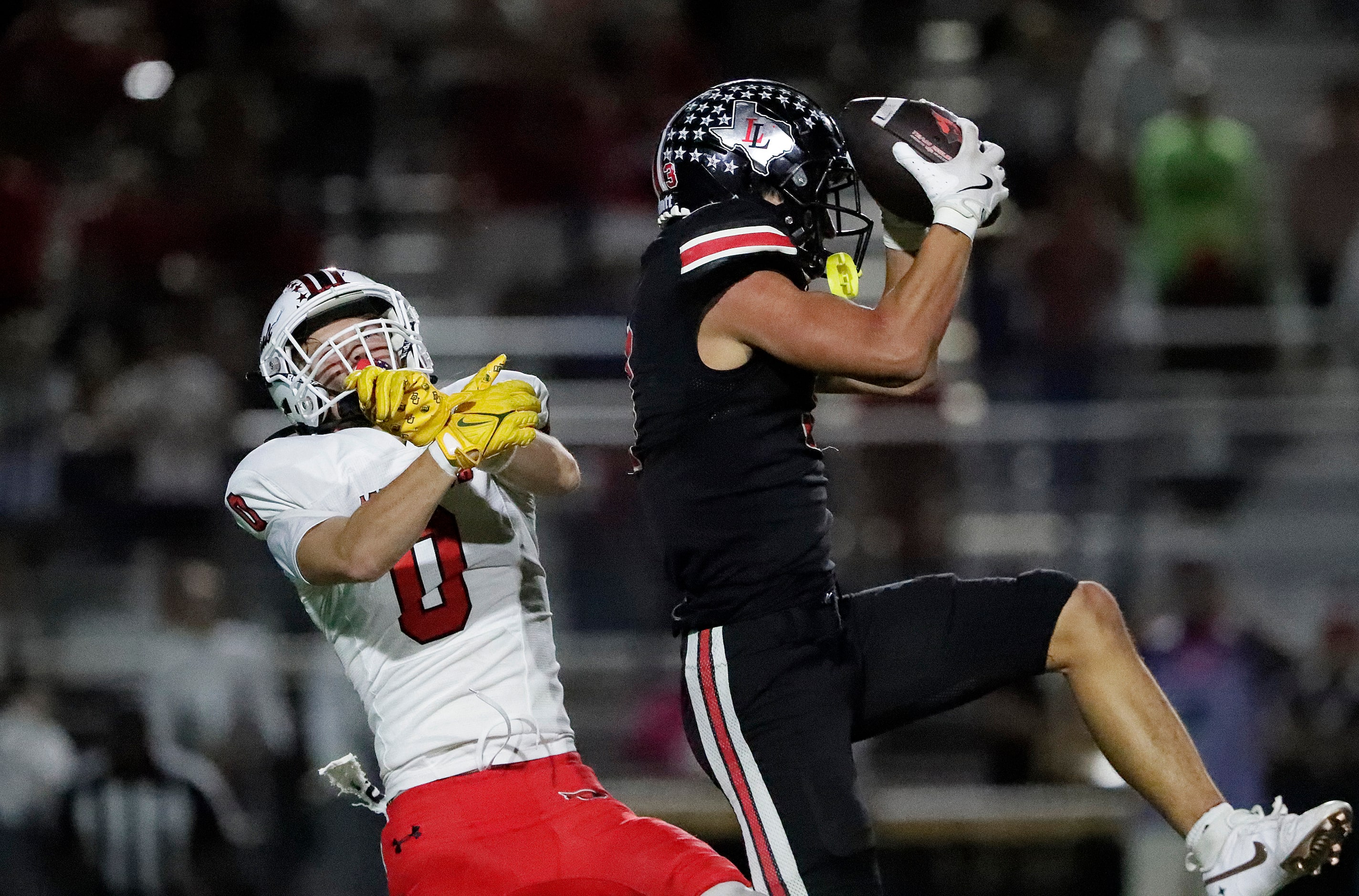 Lovejoy High School defensive back RJ McIntosh (3) makes an interception in front of Melissa...