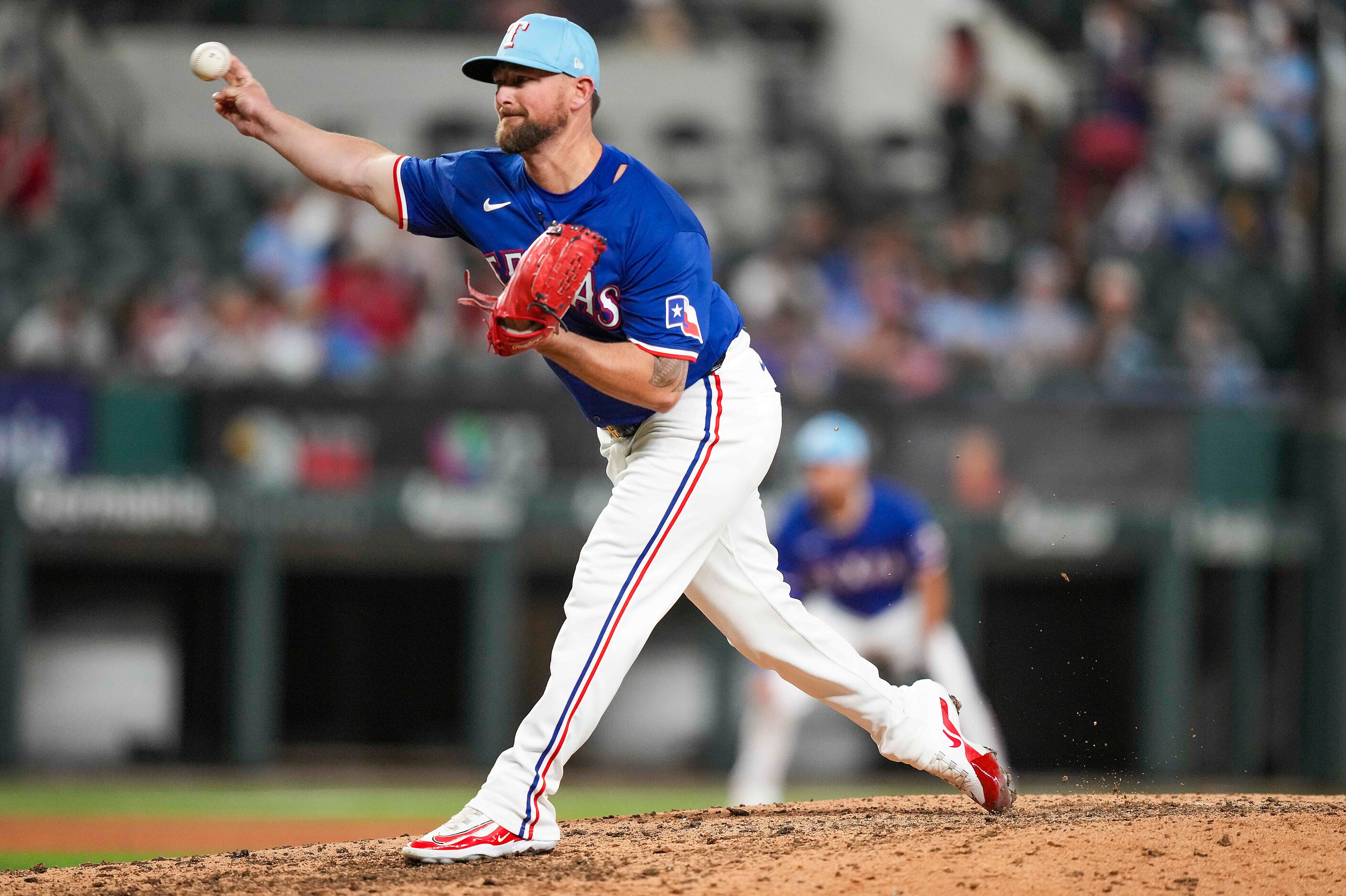 Texas Rangers pitcher Kirby Yates delivers during the ninth inning of an exhibition baseball...