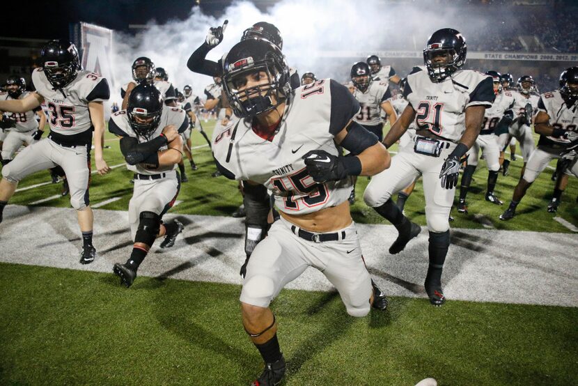 Trinity defensive back Sampson Tasini (15) leads the traditional Tongan 'Sipi Tau' war dance...