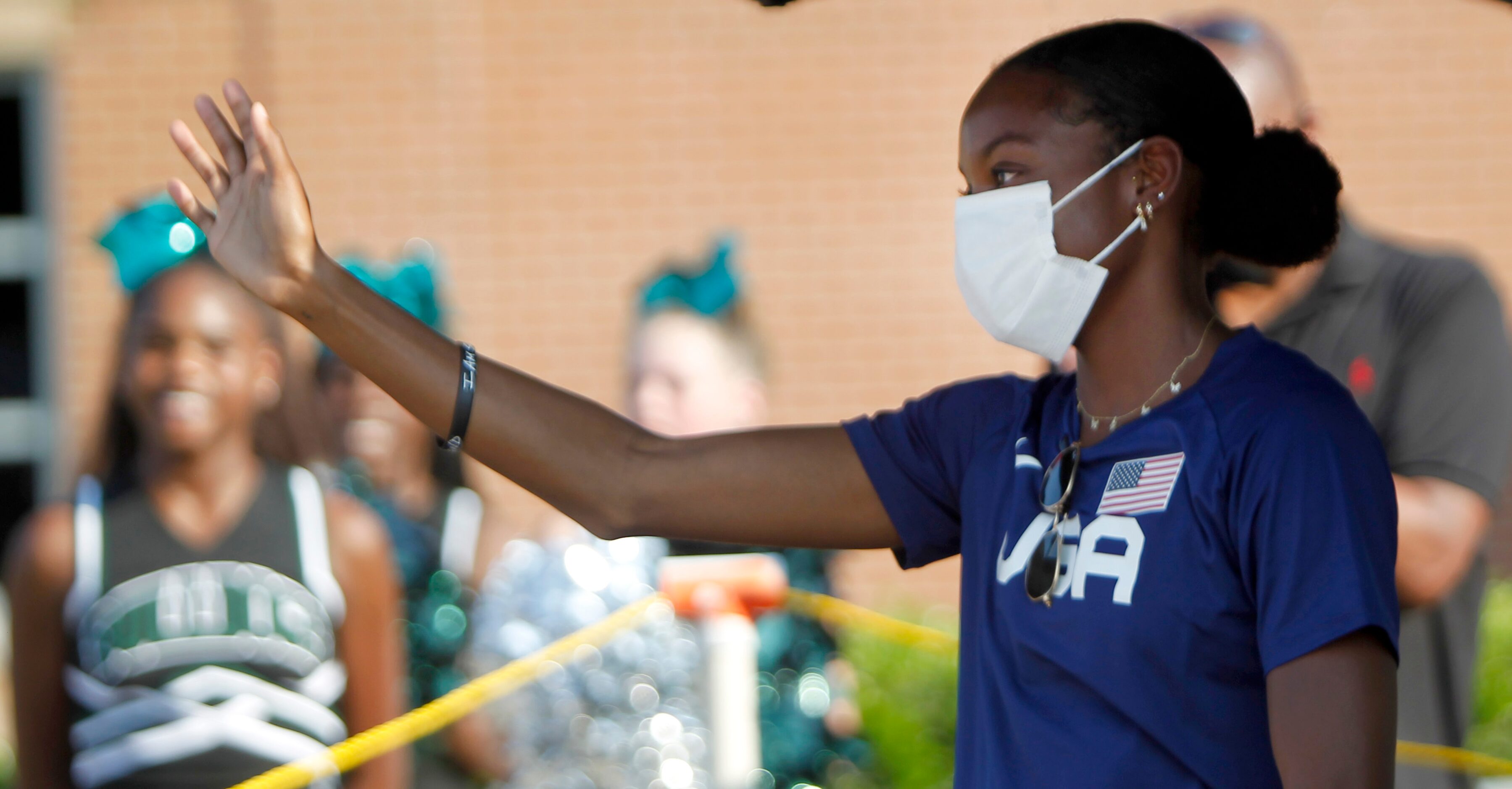 Jasmine Moore waves to supporters of the Mansfield track star as she prepares to depart to...