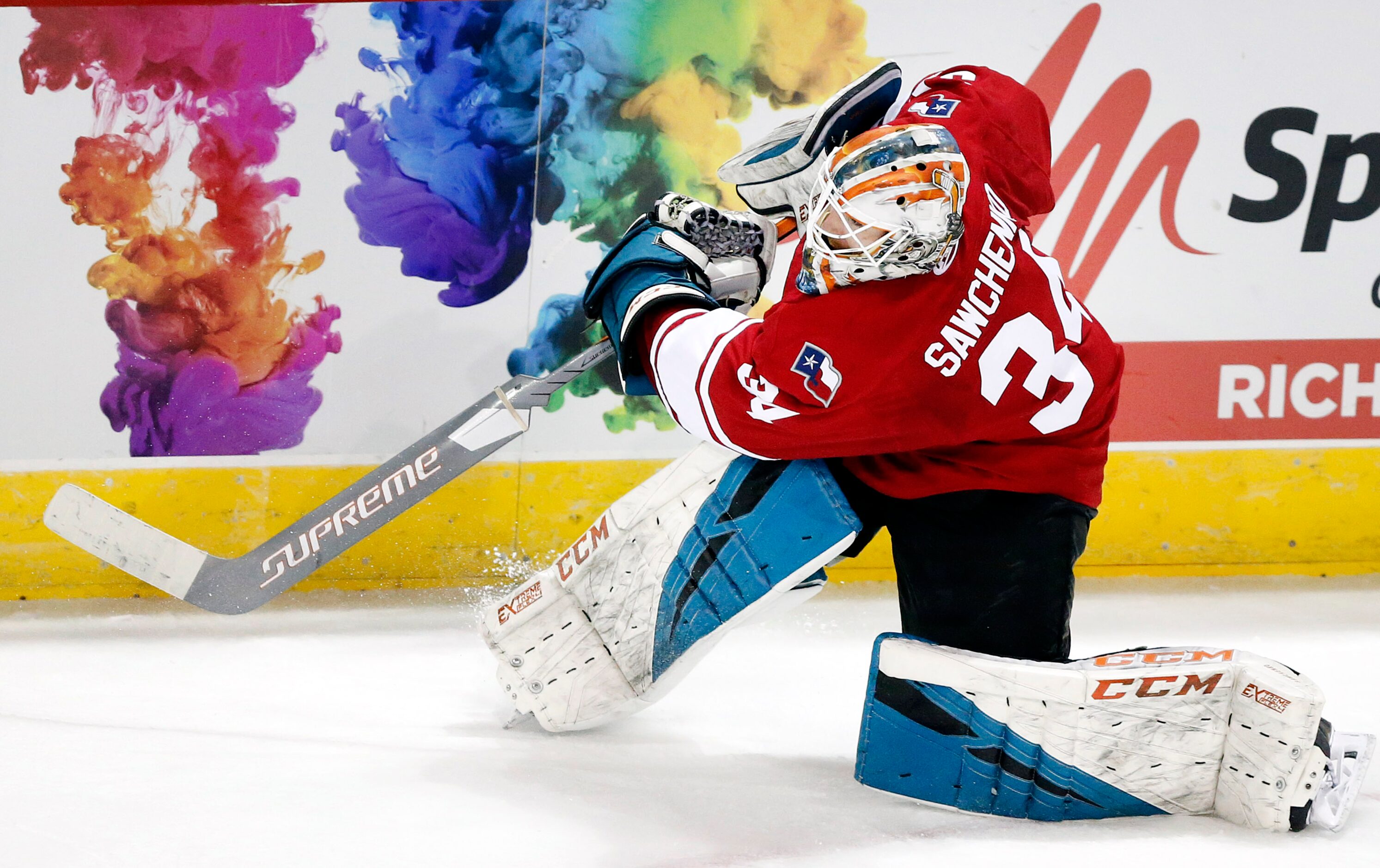 Allen Americans goalie Zach Sawchenko (34) clears the puck along the boards against the...