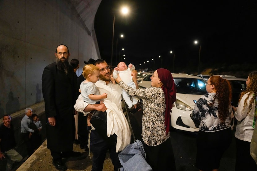 People take cover on the side of the road as a siren sounds a warning of incoming missiles...