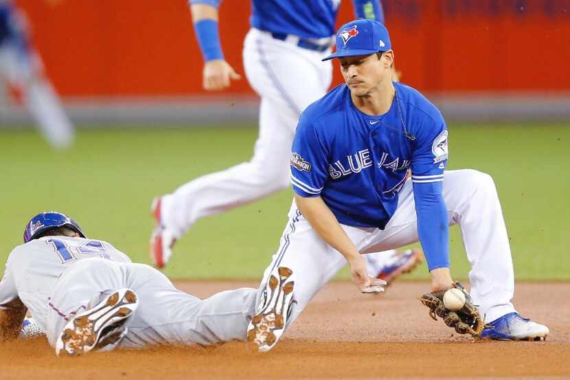 FILE - Ian Desmond, of the Texas Rangers, steals second base as Darwin Barney, of the...