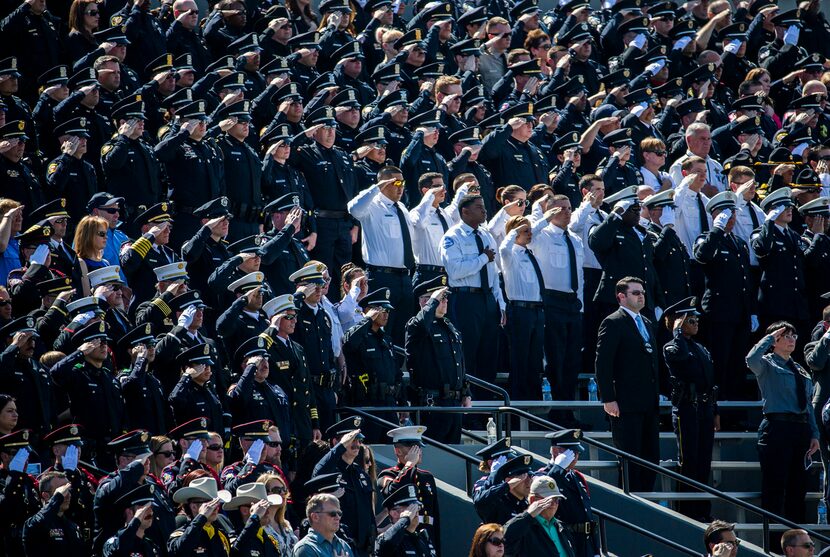  Officers salute during a memorial service for Euless police officer David Hofer on...