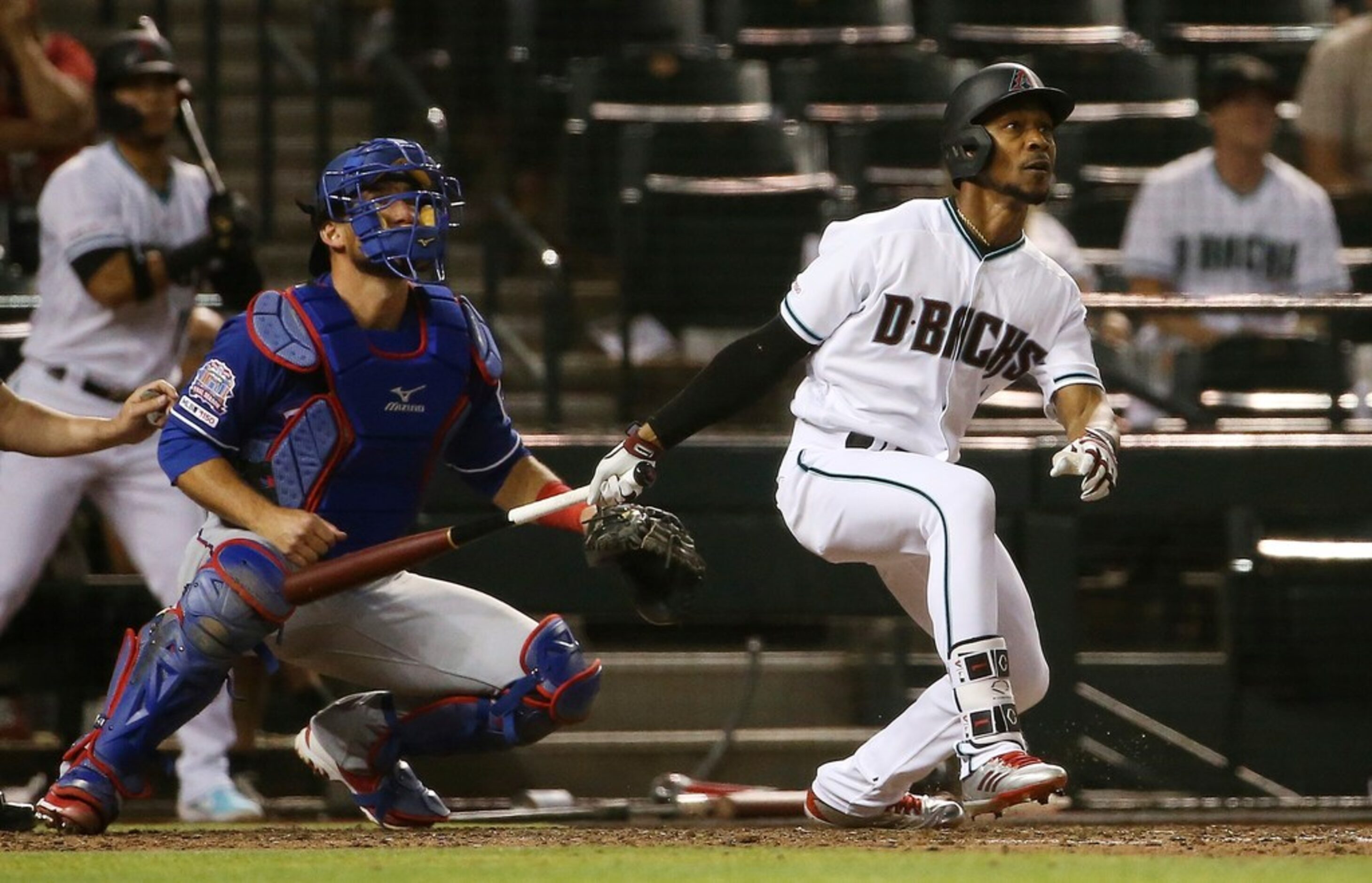 Arizona Diamondbacks' Jarrod Dyson, right, watches his walk-off, two-run home run next to...