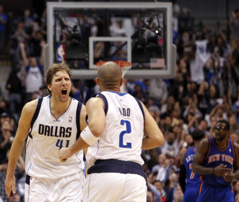 Dallas' Dirk Nowitzki (41) yells to teammate Jason Kidd (2) after Kidd sunk a three-pointer...