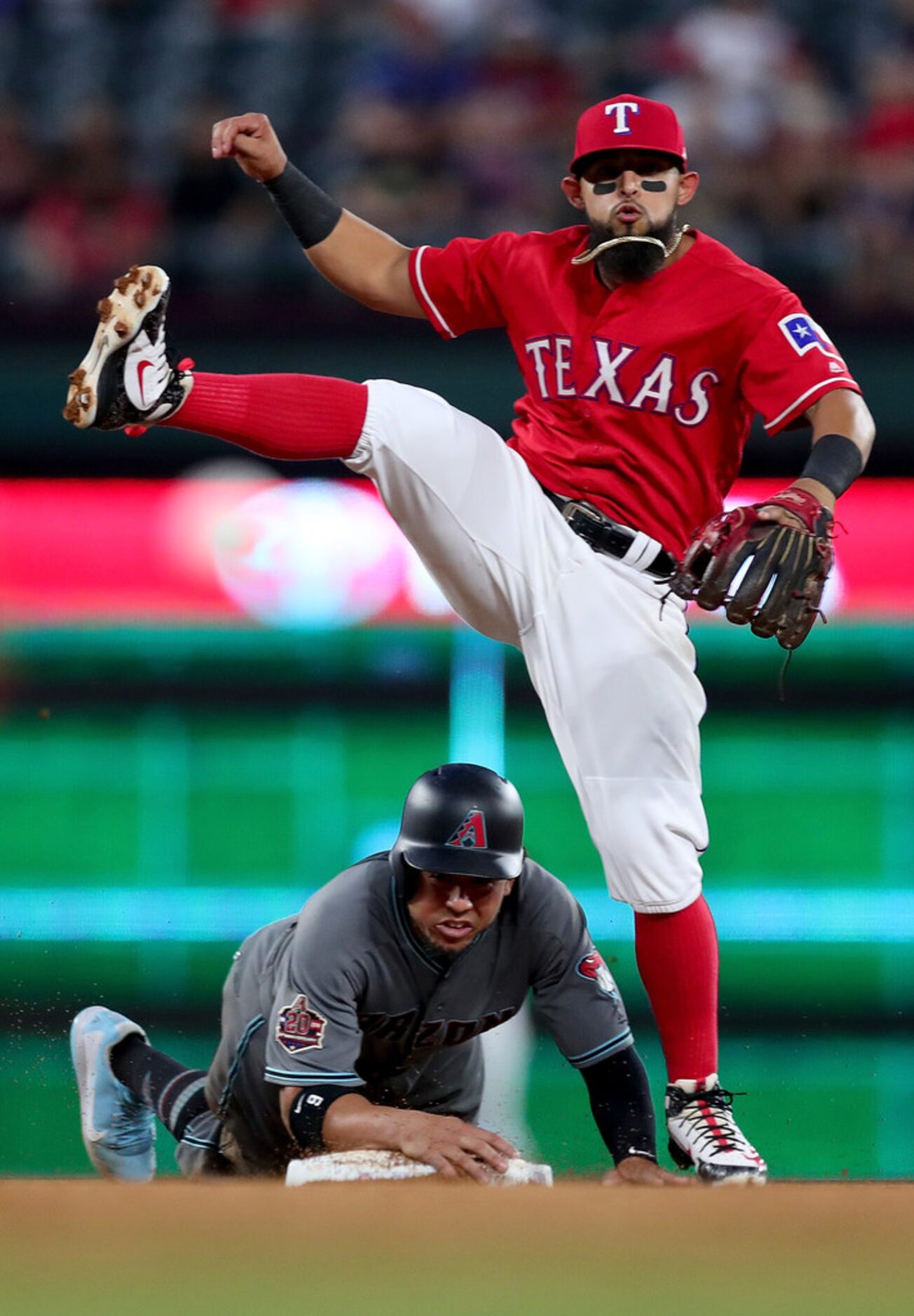 ARLINGTON, TX - AUGUST 14:  Rougned Odor #12 of the Texas Rangers turns a double play...