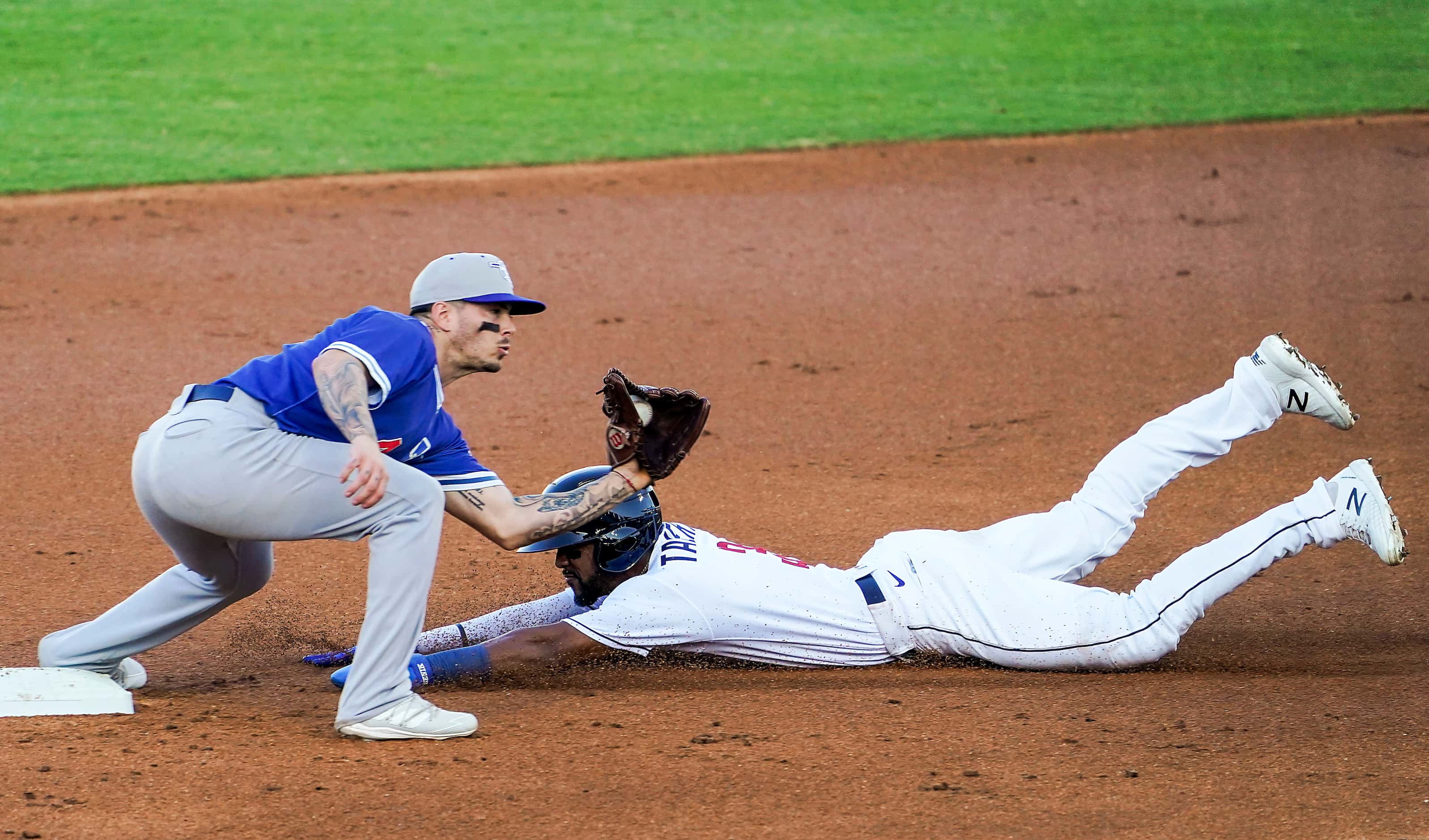 Round Rock Express outfielder Leody Taveras steals second base ahead of the tag from...