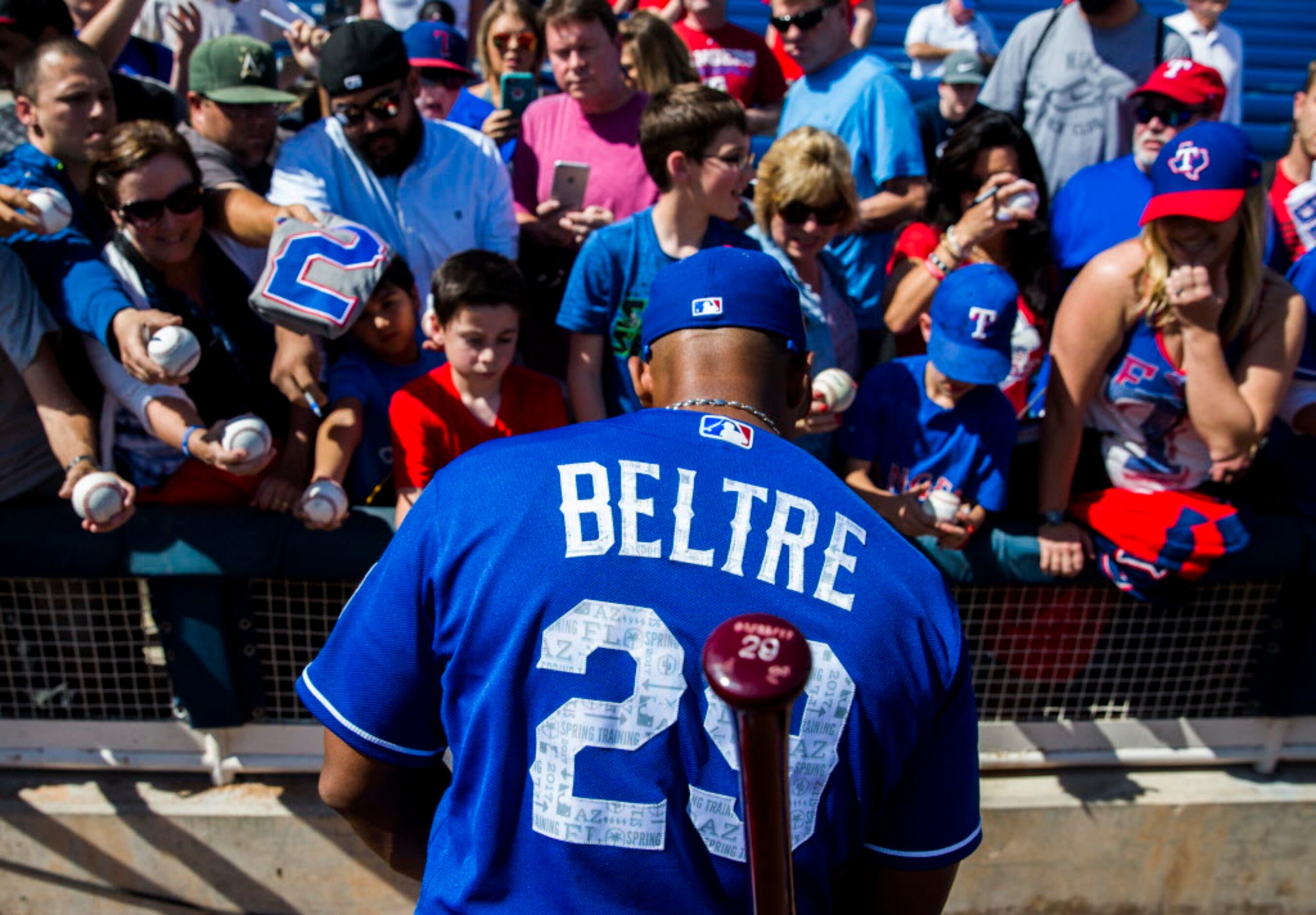 Texas Rangers third baseman Adrian Beltre (29) signs autographs for fans before a spring...