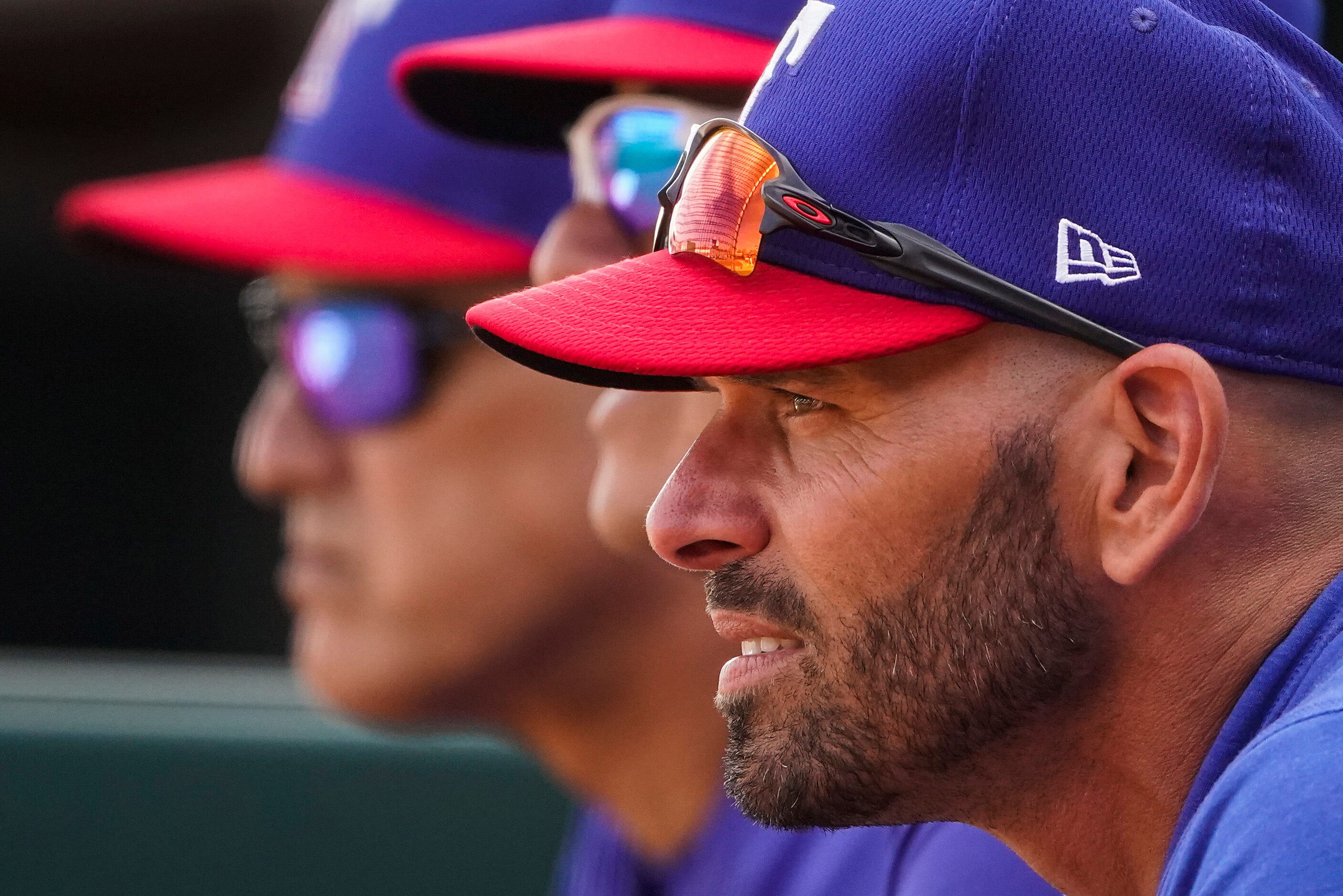 Texas Rangers manager Chris Woodward watches during the first inning of a spring training...