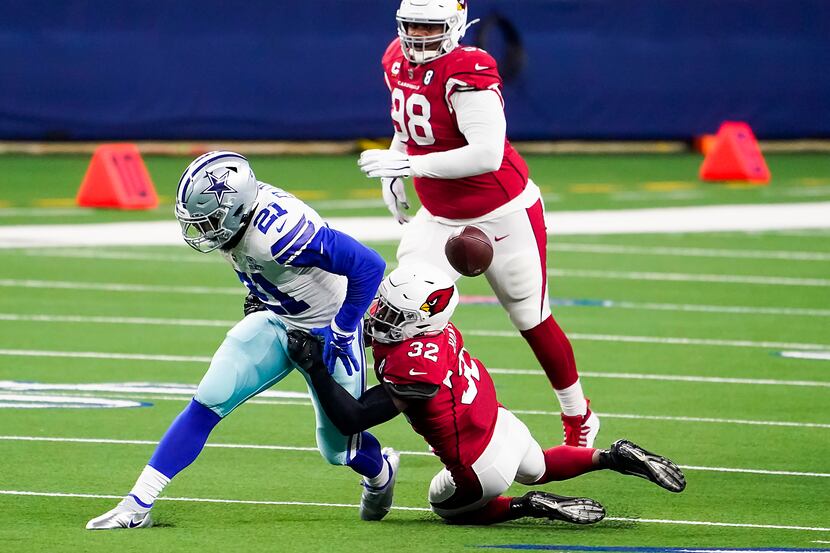 Dallas Cowboys running back Ezekiel Elliott (21) fumbles on a hit from Arizona Cardinals...