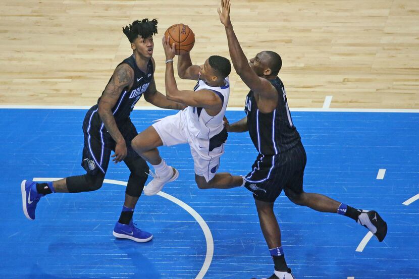 Dallas Mavericks guard Dennis Smith Jr. (1) drives between Orlando Magic guard Elfrid Payton...
