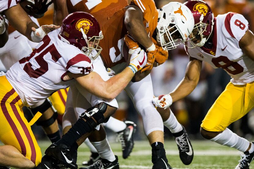 Texas Longhorns wide receiver Collin Johnson (9) is tackled by USC Trojans linebacker...