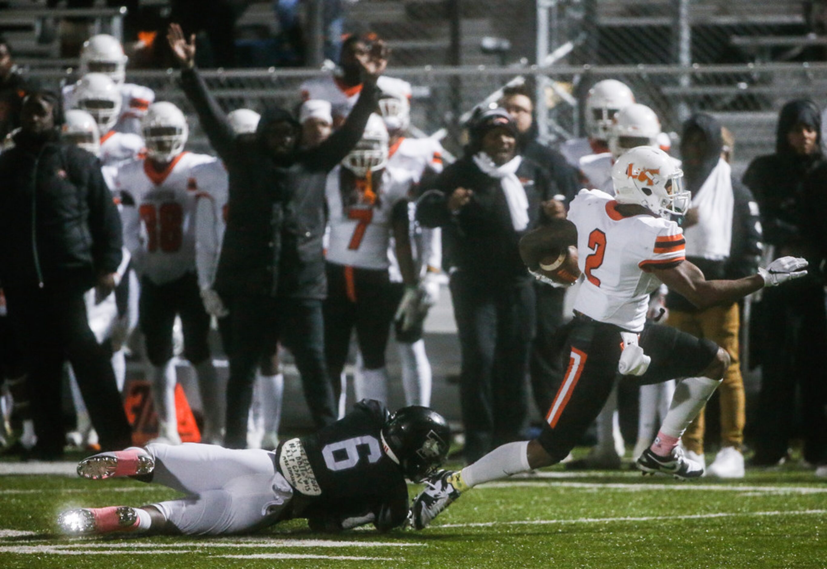 Lancaster running back Tre Bradford (2) attempts a touchdown run past Mansfield Timberview...