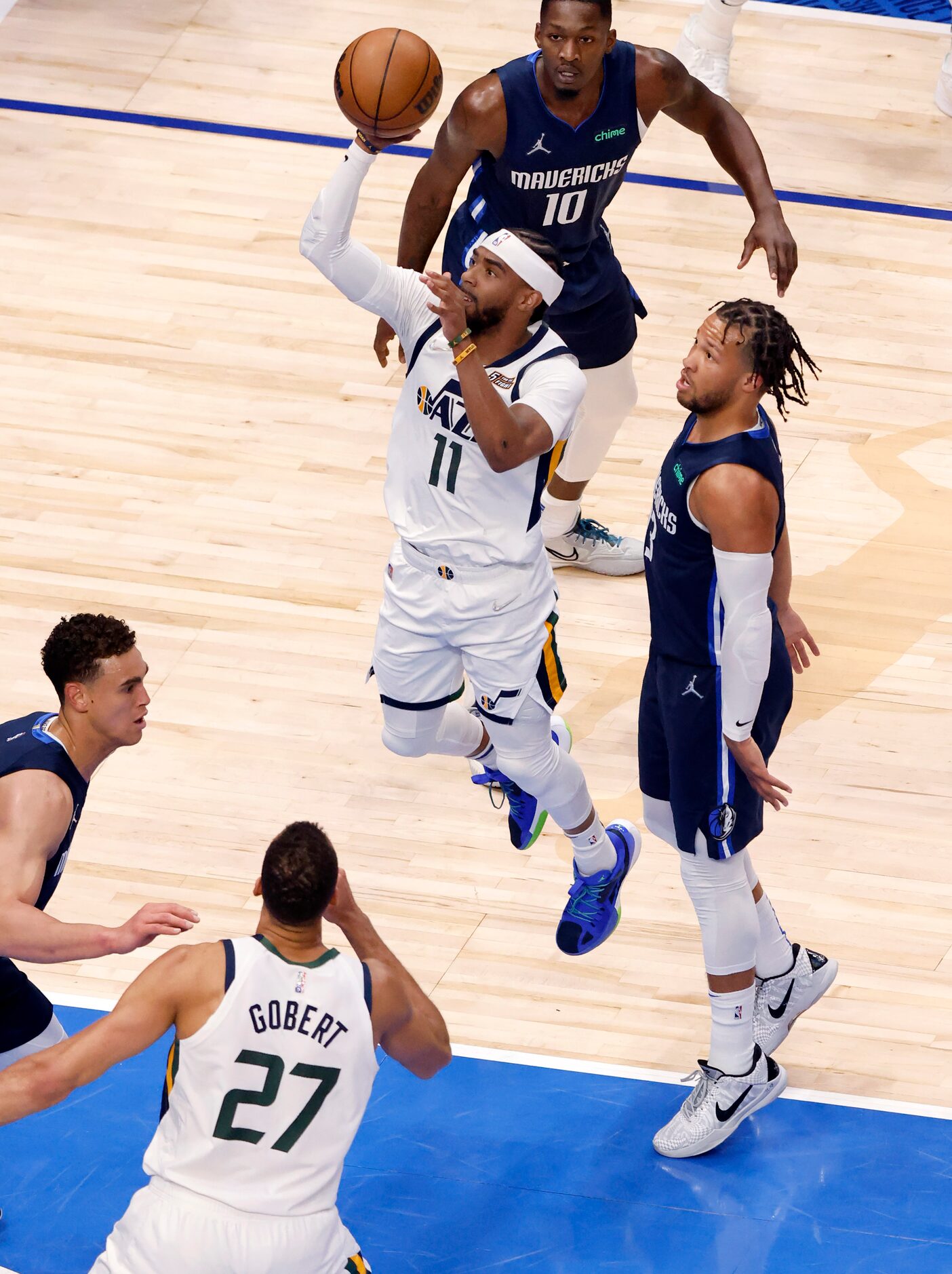 Utah Jazz guard Mike Conley (11) drives past Dallas Mavericks guard Jalen Brunson (13) for a...