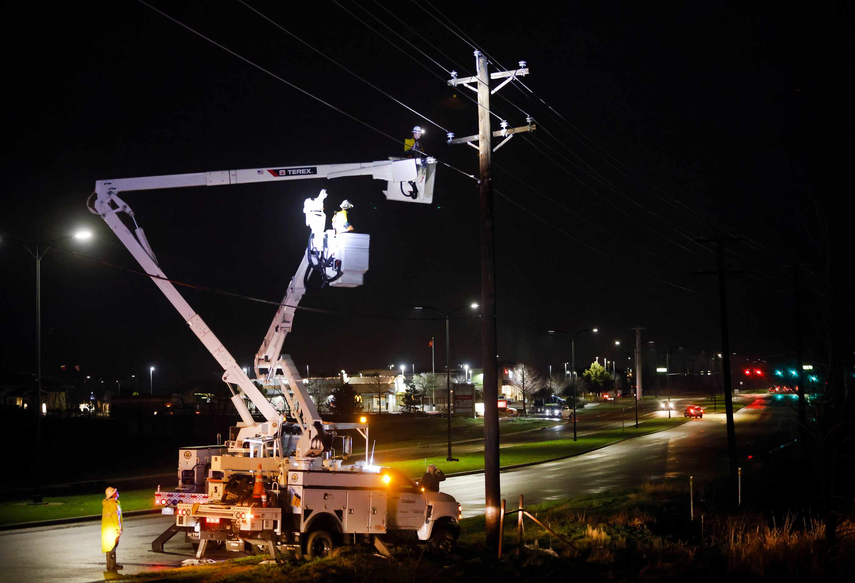Electrical crews repair a line along Main St in The Colony after a line of thunderstorms...