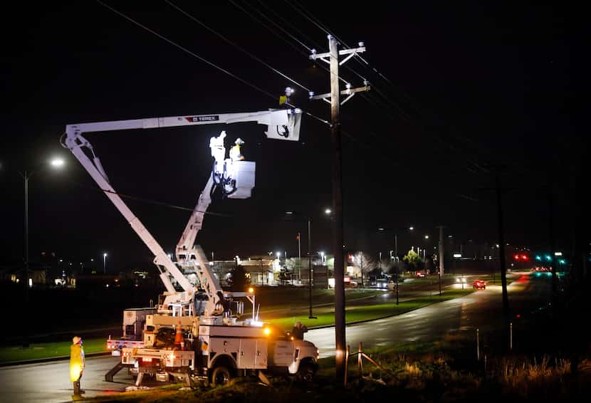 Electrical crews repair a line along Main St in The Colony after a line of thunderstorms...