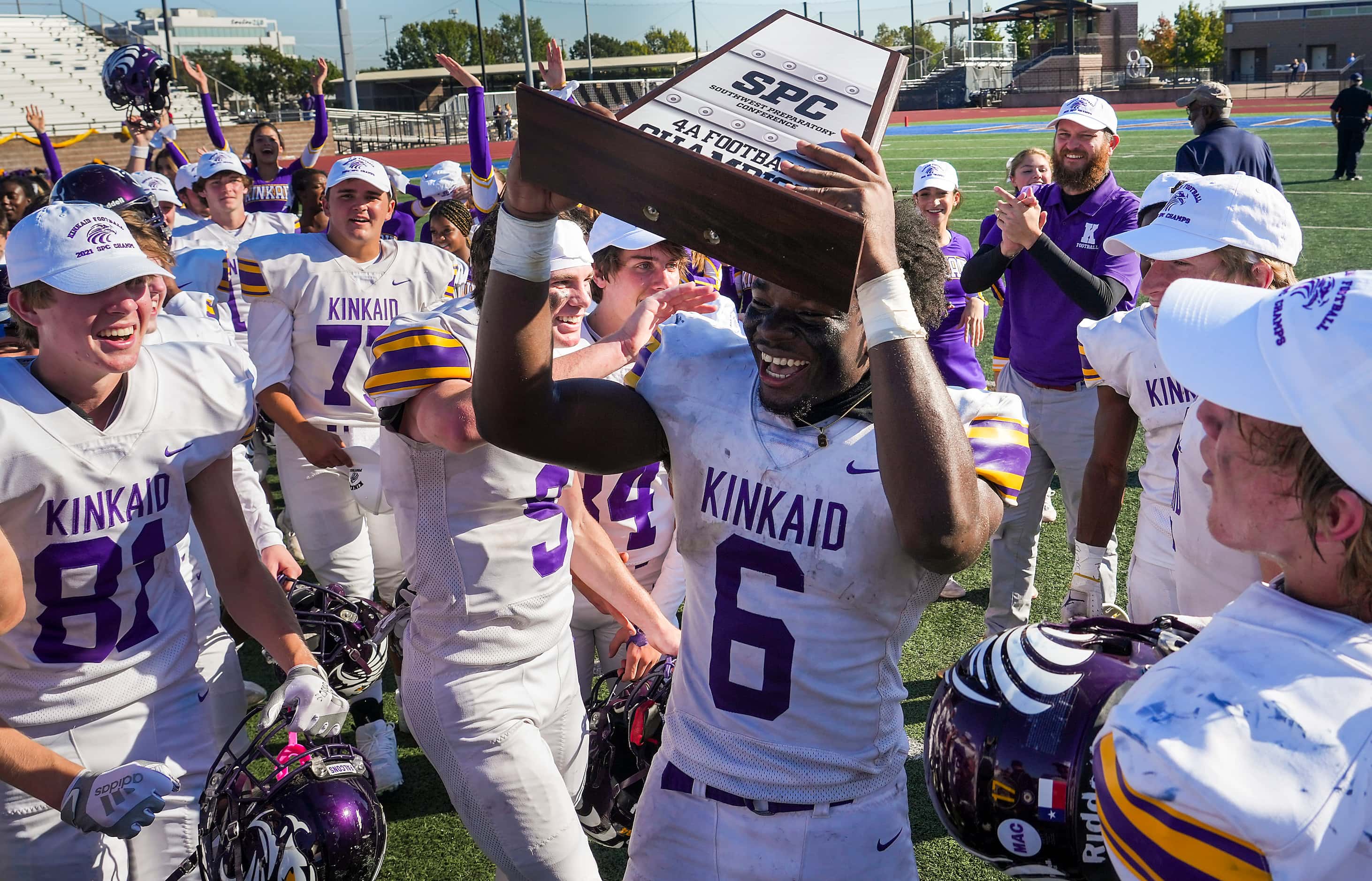 Houston Kinkaid wide receiver Dillon Bell (6) celebrates with the championship trophy as his...
