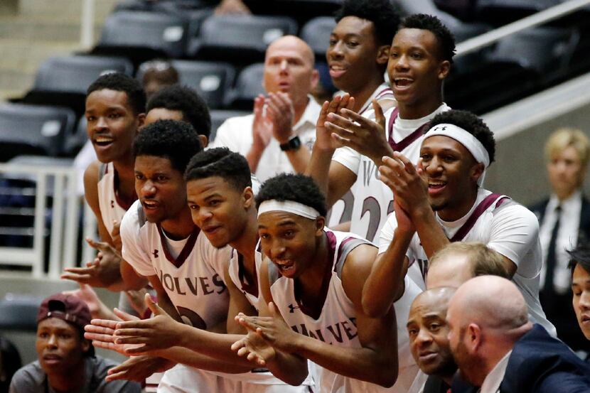 The Mansfield Timberview's bench cheer on the team in the final period of the team's 45-44...