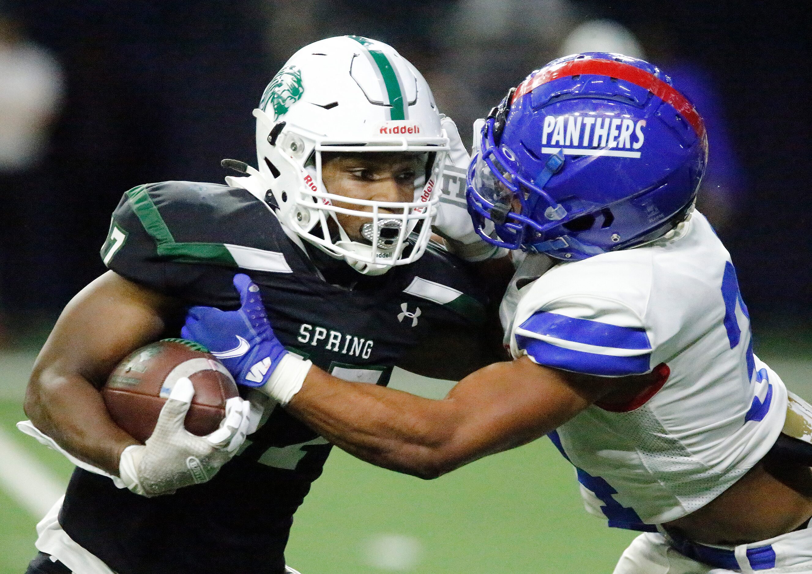 Spring High School running back Joey Fussell Jr (17) is met in the backfield by Duncanville...