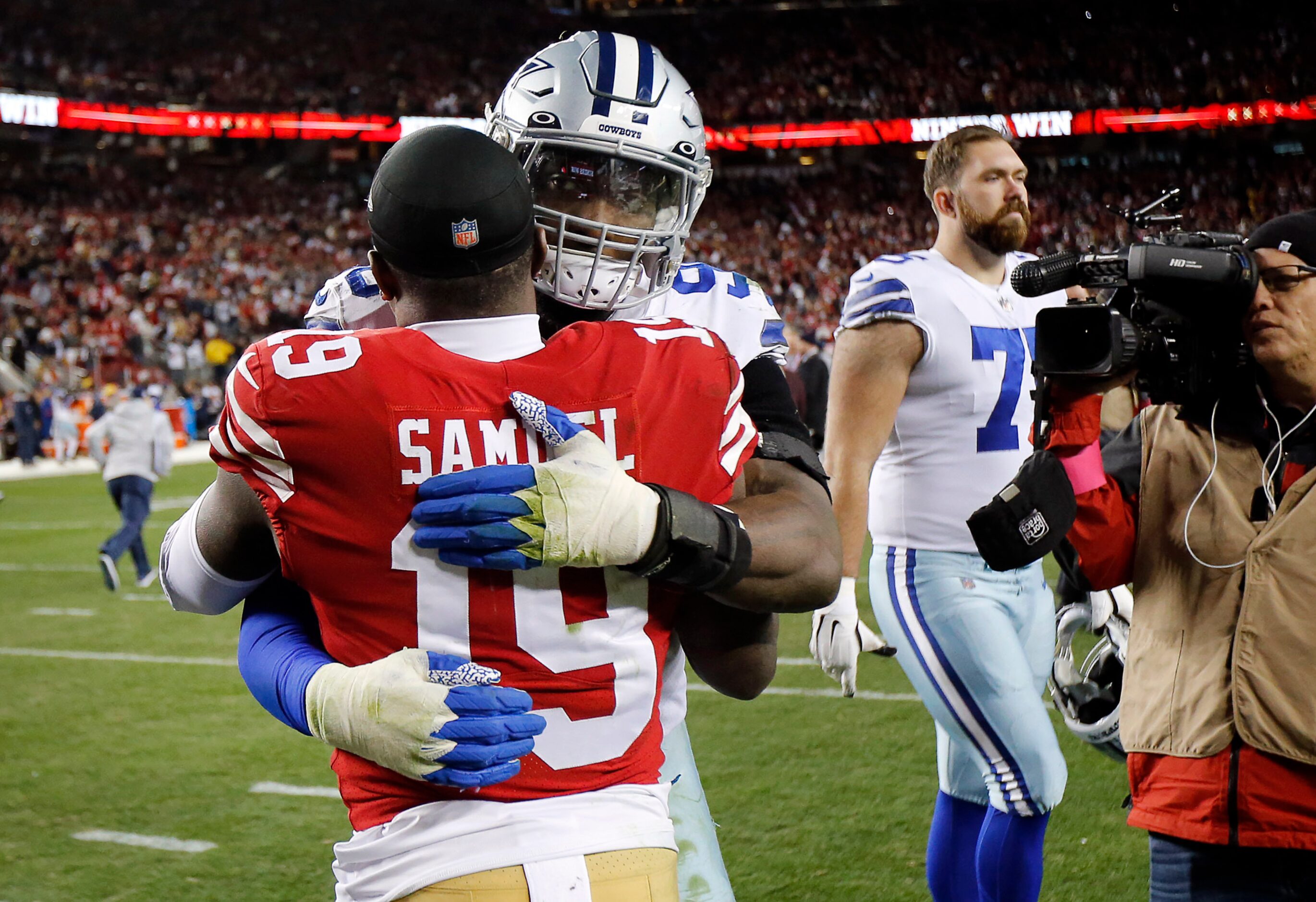 Dallas Cowboys defensive end DeMarcus Lawrence (90) congratulates San Francisco 49ers wide...