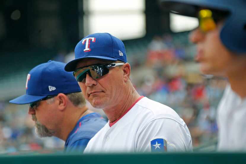 Texas Rangers manager Jeff Banister (28) watches the action from the dugout during the...