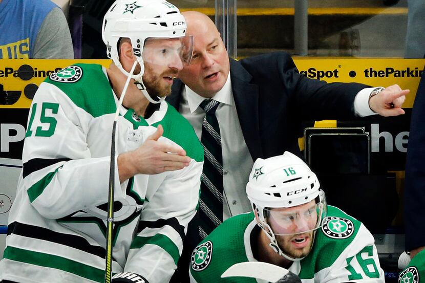 Dallas Stars head coach Jim Montgomery and left wing Blake Comeau (15) compare notes on the...