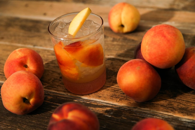 A peach cocktail with rum and ginger July 10, 2019 in The Dallas Morning News Test Kitchen...