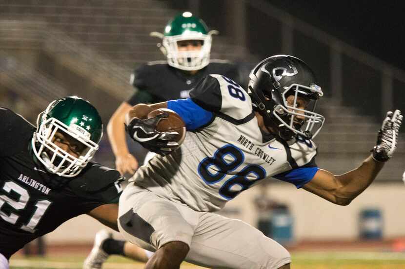 North Crowley wide receiver Chris Taylor (88) attempts to rush through the defense during a...