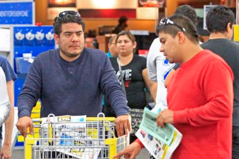 
Carlos Iguerra (left) and Juan Iguerra shop during Black Friday at Best Buy in McAllen.
