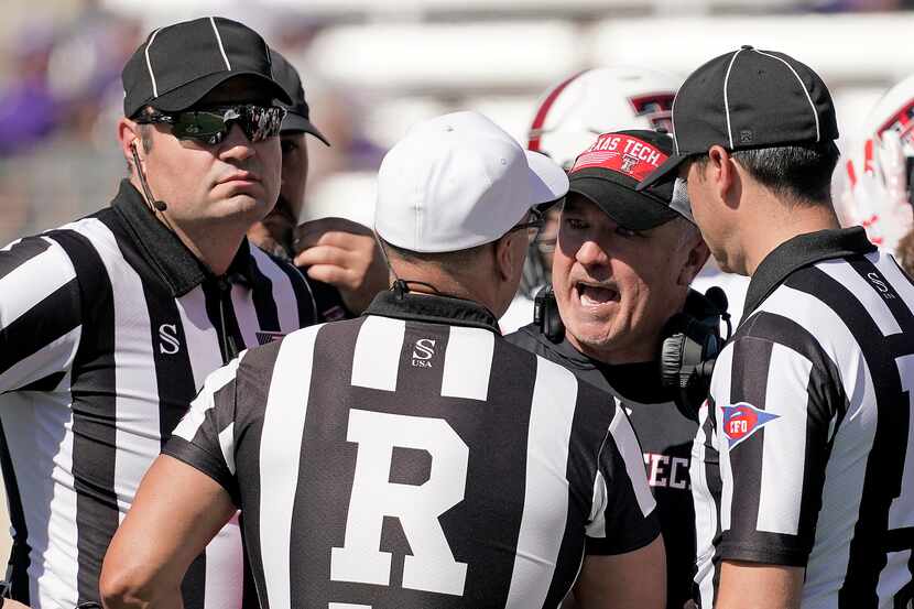 Texas Tech head coach Joey McGuire talks to officials during the second half of an NCAA...