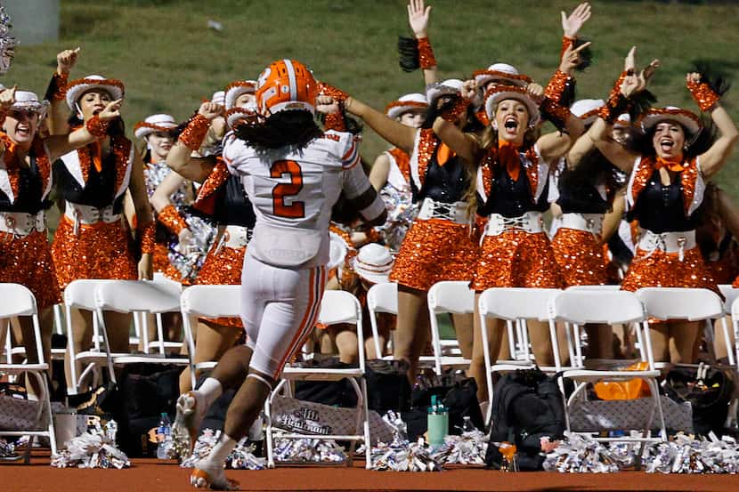 Rockwall's Ashten Emory (2) celebrates after scoring a touchdown during the second half of a...