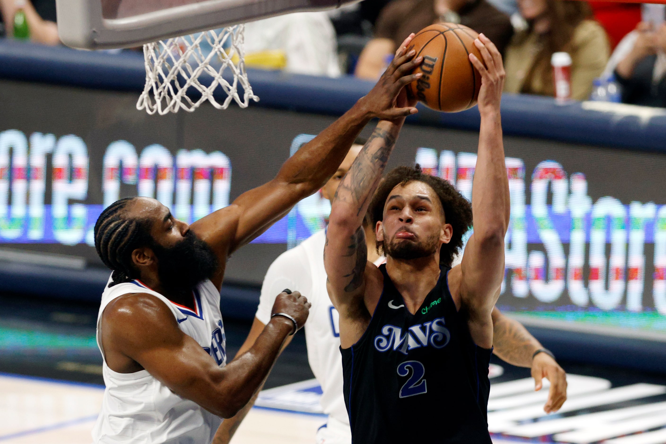 LA Clippers guard James Harden (1) fouls Dallas Mavericks center Dereck Lively II (2) as he...