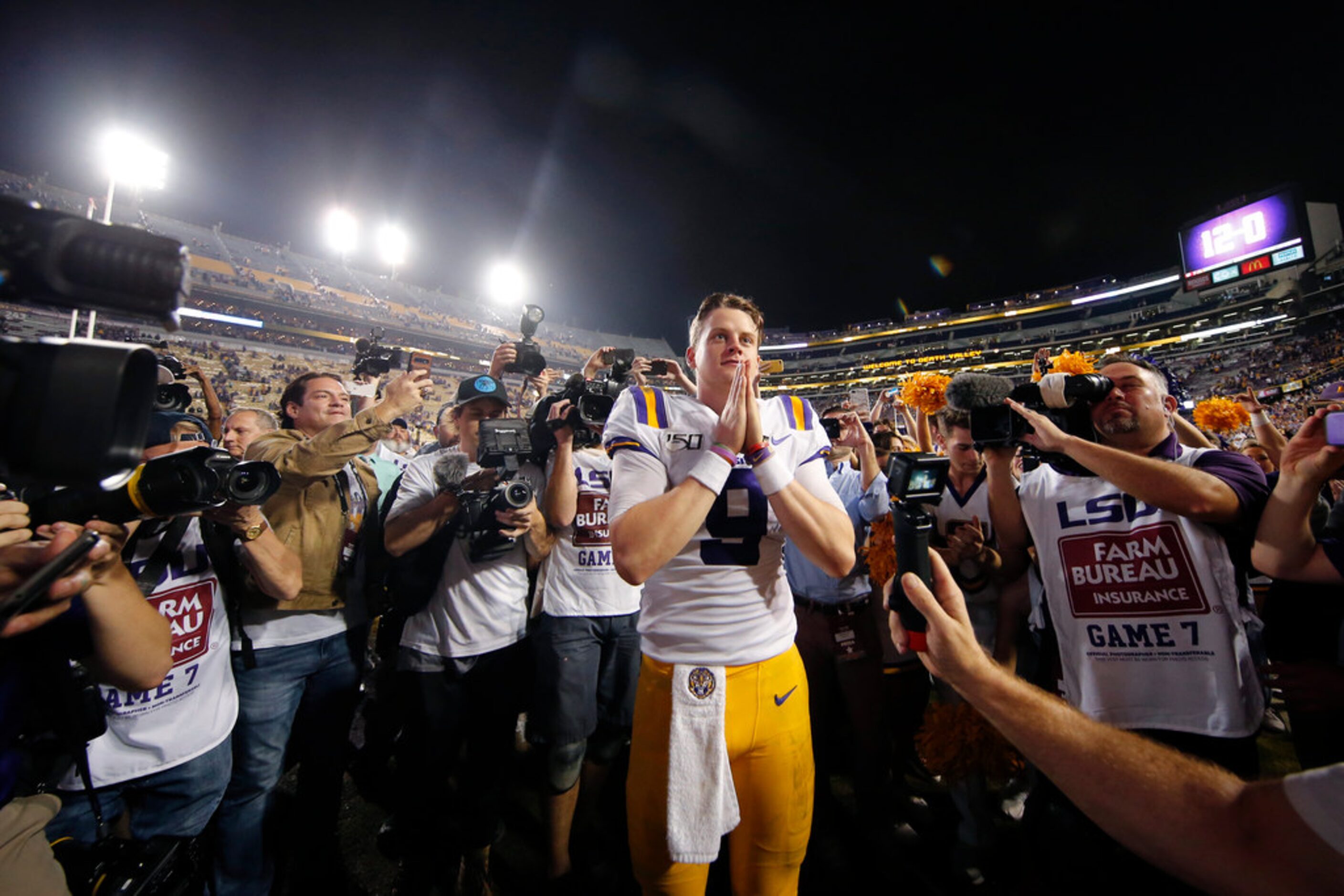 LSU quarterback Joe Burrow (9) gestures thanks to the student section after playing his last...