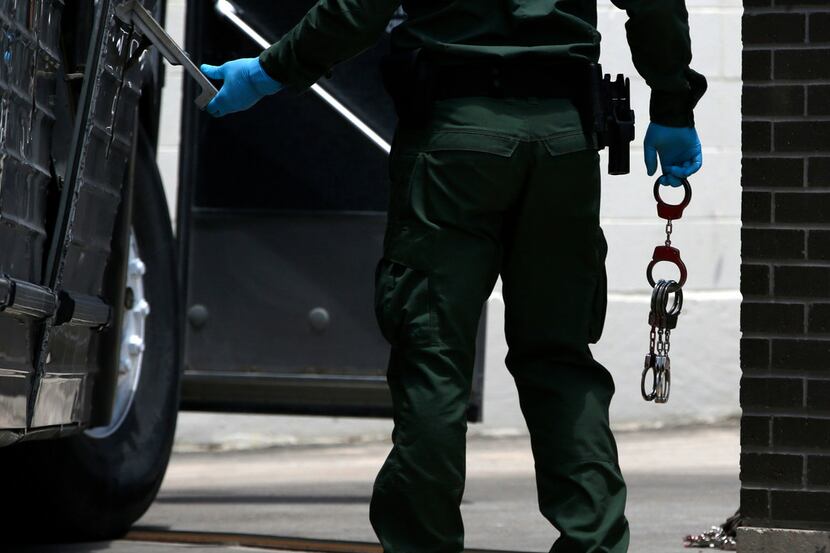 A U.S. Border patrol officer loaded up handcuffs (shown), along with chains and shackles...