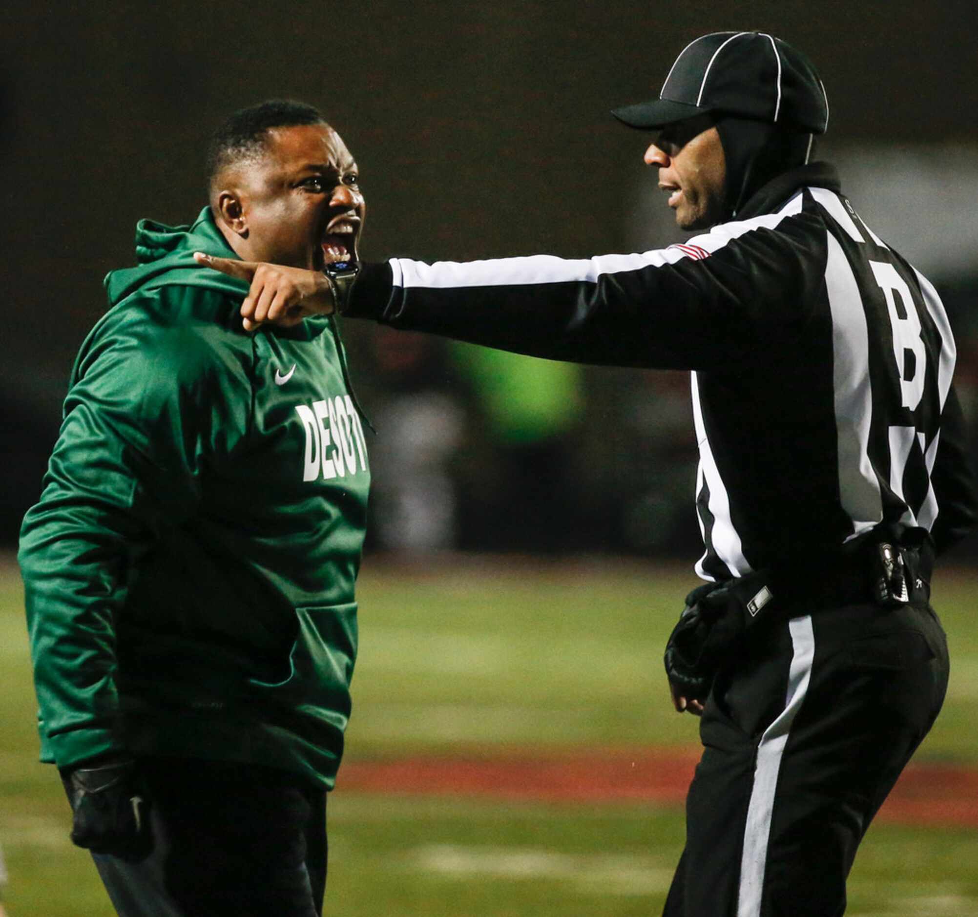 DeSoto head coach Claude Mathis disputes an official's call during a high school football...
