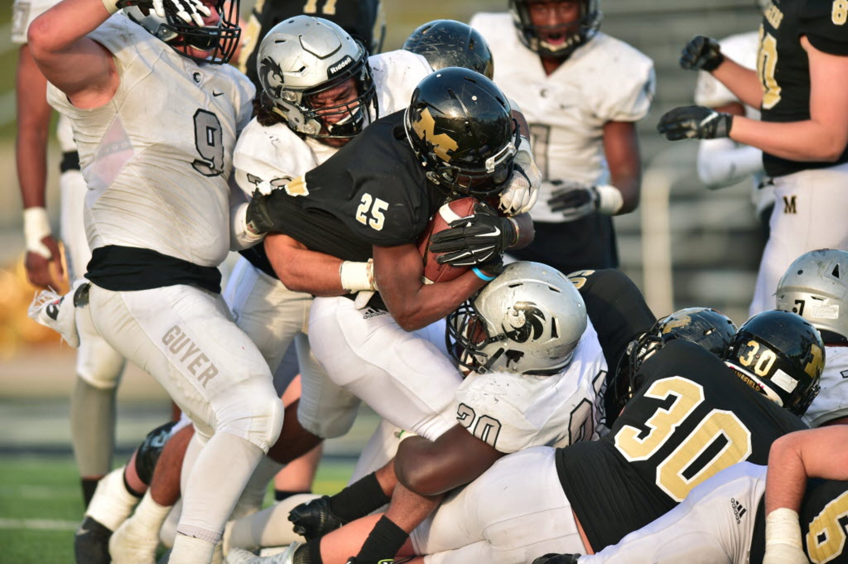 Guyer senior linebacker Michael Carillo (32) and senior defensive lineman PJ Brousard (20)...