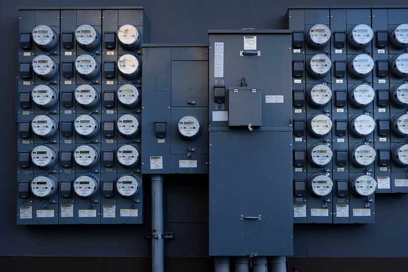 Rows of apartment electrical meters line a wall near downtown Dallas on Wednesday, June 30,...