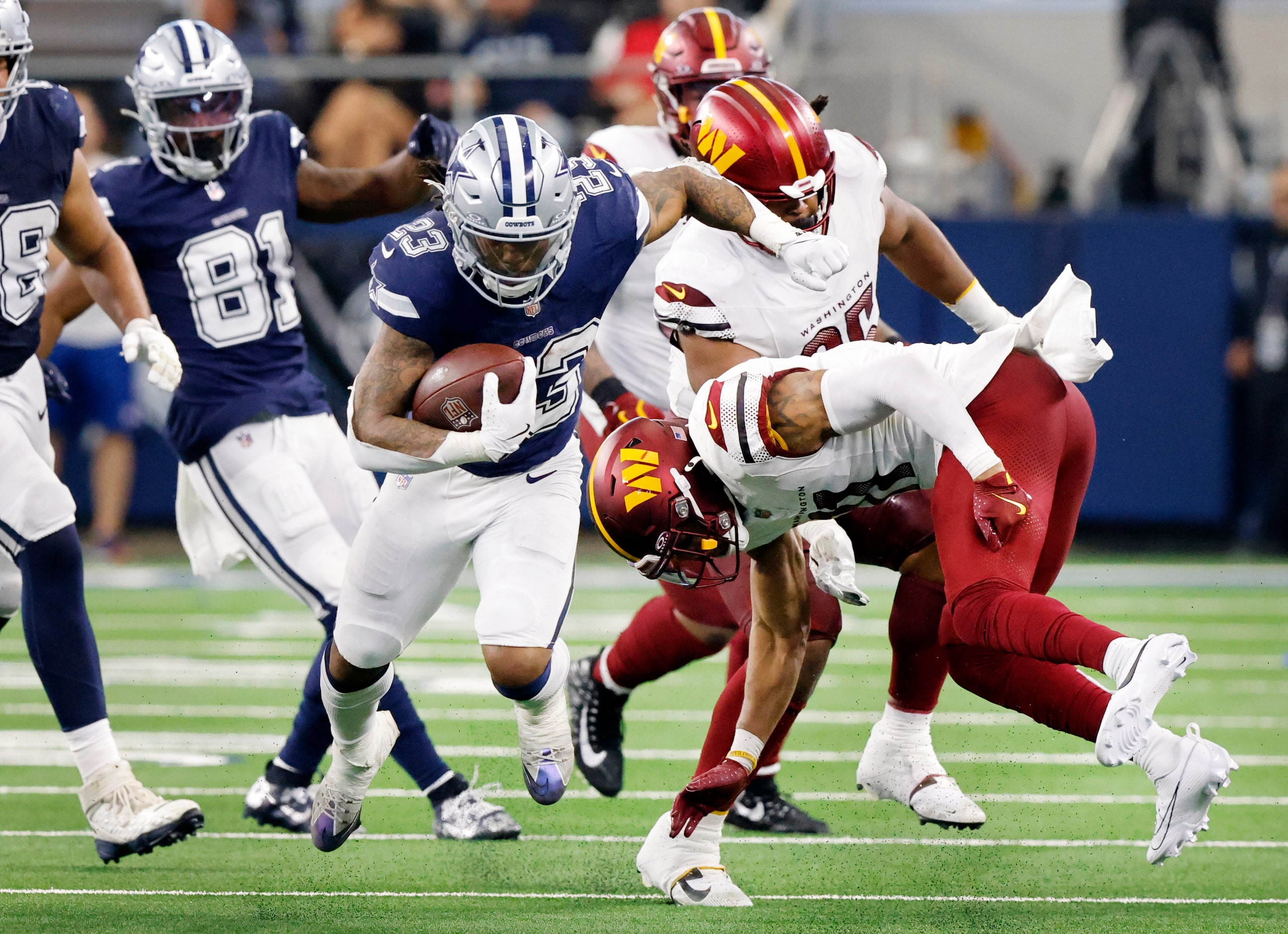 Dallas Cowboys running back Rico Dowdle (23) carries the ball as he avoids Washington...