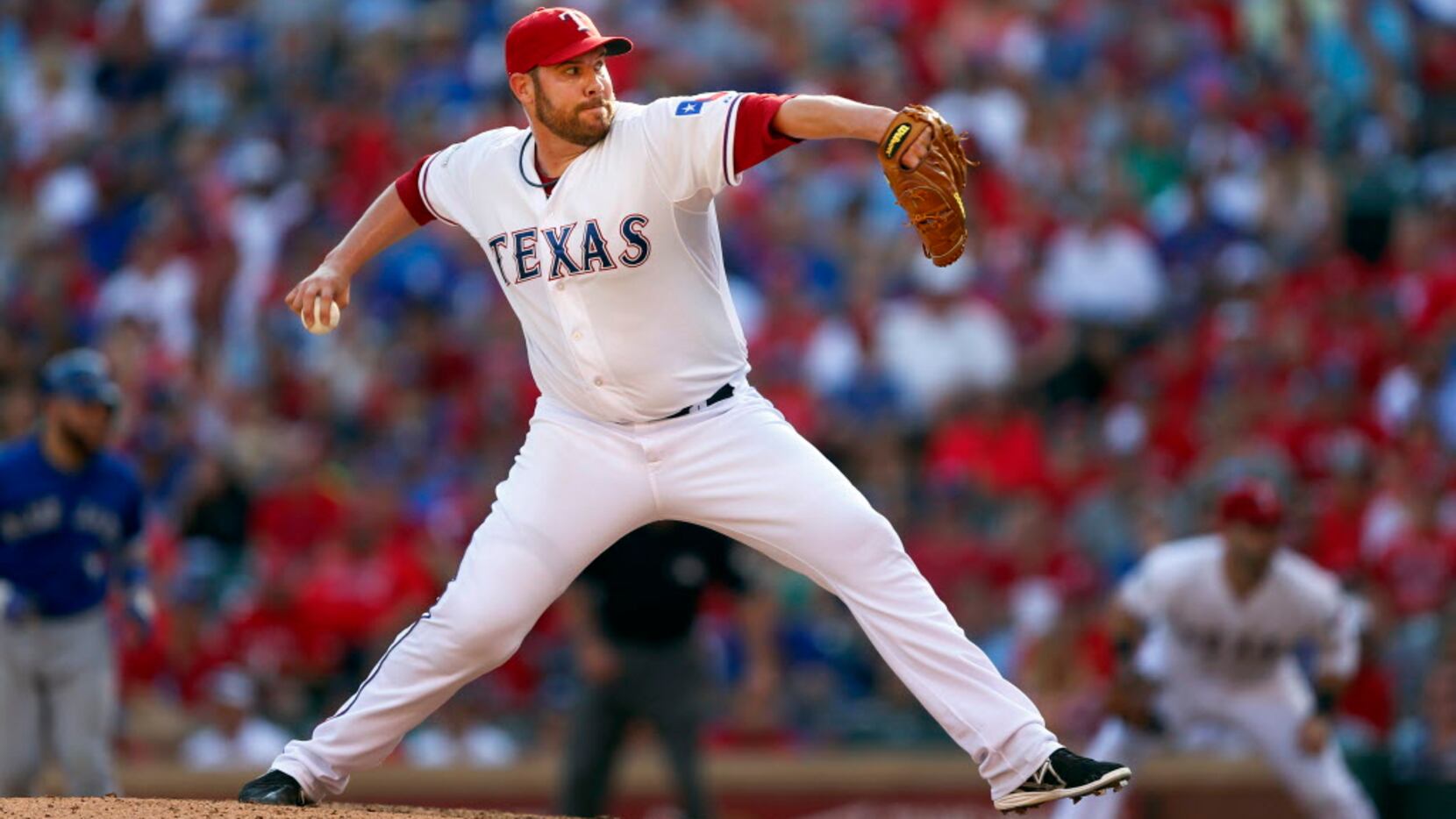 Texas Rangers relief pitcher Colby Lewis (48) throws against the Toronto Blue Jays in Game 4...